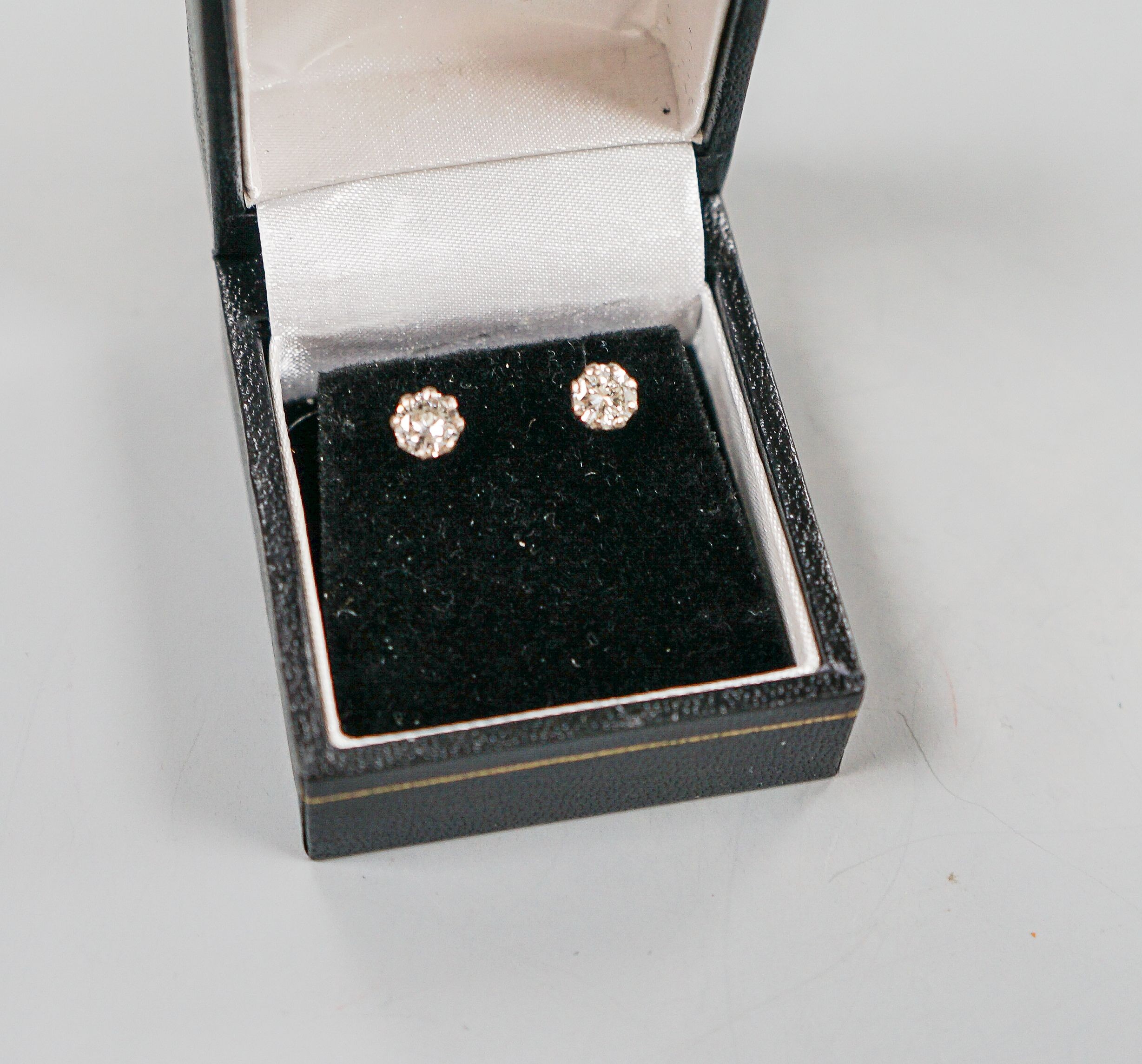 A pair of 750 white metal and solitaire diamond ear studs, gross weight 2 grams